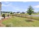 Spacious backyard with a black fence, screened patio and lake view at 511 Ocean Mist Way, Summerville, SC 29486