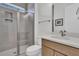 Modern bathroom features tiled walk-in shower with glass enclosure, white countertops and wood cabinets at 511 Ocean Mist Way, Summerville, SC 29486