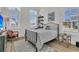 Sunlit bedroom with contemporary furnishings, plantation shutters, and hardwood floors at 511 Ocean Mist Way, Summerville, SC 29486