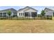 Rear exterior showcasing a screened patio and fenced yard, offering privacy and outdoor living space at 511 Ocean Mist Way, Summerville, SC 29486