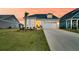 A beautiful home with a well-kept lawn, two car garage, and inviting entryway at sunset at 511 Ocean Mist Way, Summerville, SC 29486