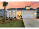 Charming home featuring a well-manicured lawn, a palm tree, and a two-car garage at sunset at 511 Ocean Mist Way, Summerville, SC 29486