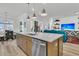 Open-concept kitchen island with stainless steel dishwasher and views into the living room at 511 Ocean Mist Way, Summerville, SC 29486