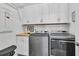 Laundry room offers white cabinets, wood countertops, washer and dryer with modern conveniences at 511 Ocean Mist Way, Summerville, SC 29486