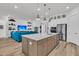 Bright open-concept living room with kitchen, large island, stainless appliances, and modern decor at 511 Ocean Mist Way, Summerville, SC 29486