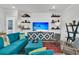 Comfortable living room features a large blue couch, TV and modern shelving at 511 Ocean Mist Way, Summerville, SC 29486