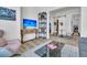Cozy living room showcasing a TV, stylish shelving unit, and a view into the adjacent room at 511 Ocean Mist Way, Summerville, SC 29486
