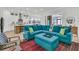Bright open-concept living room with a blue L-shaped couch that flows into the kitchen at 511 Ocean Mist Way, Summerville, SC 29486