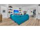 A modern living room with TV, modern shelving and L-shaped blue couch at 511 Ocean Mist Way, Summerville, SC 29486