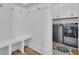 Mudroom with seating bench, hooks, and access to laundry room with washer and dryer at 511 Ocean Mist Way, Summerville, SC 29486