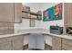 Functional home office with custom built-in desk, cabinets, and shelving, enhanced by a colorful painting at 511 Ocean Mist Way, Summerville, SC 29486