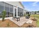 Open-air patio with brick flooring and dark seating, perfect for relaxing in the landscaped backyard at 511 Ocean Mist Way, Summerville, SC 29486