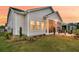 A rear view showcasing the large windows of the sunroom at 511 Ocean Mist Way, Summerville, SC 29486