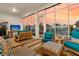 Comfortable screened porch with cozy seating, a TV, and serene outdoor views at 511 Ocean Mist Way, Summerville, SC 29486