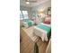 Cozy bedroom with twin beds, white linens, colorful accents, and natural lighting at 519 Parkdale Dr # J, Charleston, SC 29414