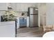 Bright kitchen with stainless steel appliances, white cabinets, and durable, new floors at 519 Parkdale Dr # J, Charleston, SC 29414