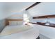Cozy attic bedroom with angled ceilings, wood beams, and soft natural light creating a snug space at 554 Double Eagle Trce, Seabrook Island, SC 29455
