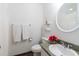 Bathroom featuring a round mirror, a white sink, and a shower with a curtain at 554 Double Eagle Trce, Seabrook Island, SC 29455
