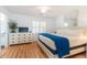 Bedroom with white walls, a queen-sized bed, a white dresser and light colored, wood-look floors at 554 Double Eagle Trce, Seabrook Island, SC 29455