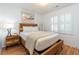 Comfortable bedroom with a wooden bed frame, neutral bedding, and natural light from the window at 554 Double Eagle Trce, Seabrook Island, SC 29455