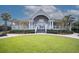 Beautiful clubhouse with lush green lawn, inviting entryway and covered porch at 554 Double Eagle Trce, Seabrook Island, SC 29455