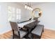 Cozy dining room with modern light fixture, shutters, table with seating, and a stylish mirror at 554 Double Eagle Trce, Seabrook Island, SC 29455