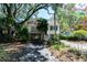 Charming coastal home with a stilt foundation and a welcoming front porch, surrounded by lush greenery and a paved driveway at 554 Double Eagle Trce, Seabrook Island, SC 29455