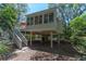Elevated architectural home is designed with a staircase, surrounded by lush trees at 554 Double Eagle Trce, Seabrook Island, SC 29455