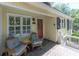 Inviting front porch with comfortable seating, a charming rug, and a view of the neighborhood at 554 Double Eagle Trce, Seabrook Island, SC 29455