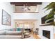 Bright living room featuring a soaring ceiling, fireplace, open dining area, and comfortable seating at 554 Double Eagle Trce, Seabrook Island, SC 29455