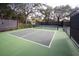 View of a tennis court with new net and benches surrounded by lush greenery, great for recreational activities at 554 Double Eagle Trce, Seabrook Island, SC 29455