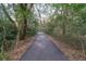 Well maintained paved path through a wooded area, offering a tranquil outdoor experience at 554 Double Eagle Trce, Seabrook Island, SC 29455