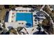 Aerial view of pool with covered lounge area, lounge chairs, and mature landscaping on a sunny day at 555 Double Eagle, Seabrook Island, SC 29455