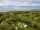 Aerial view featuring lush golf course, ocean, and residential houses at 555 Double Eagle, Seabrook Island, SC 29455