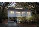 Charming coastal home with a inviting porch, staircase, and an elevated foundation amidst lush foliage at 555 Double Eagle, Seabrook Island, SC 29455