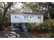Charming coastal home with a inviting porch, staircase, and an elevated foundation amidst lush foliage at 555 Double Eagle, Seabrook Island, SC 29455