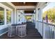 Inviting outdoor seating area with wicker chairs and table on a spacious porch with views of the manicured grounds at 555 Double Eagle, Seabrook Island, SC 29455