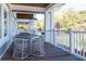 Inviting outdoor seating area with wicker chairs and table on a spacious porch with views of the manicured grounds at 555 Double Eagle, Seabrook Island, SC 29455