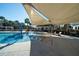 Zero entry community pool with shades, lounge seating, bathroom facilities, and palm trees on a bright day at 555 Double Eagle, Seabrook Island, SC 29455
