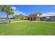 Exterior of the restaurant with outdoor seating, a well-manicured lawn, palm trees and blue skies on a sunny day at 555 Double Eagle, Seabrook Island, SC 29455
