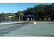 A well-maintained tennis court with a covered bench; trees and lighting in the background at 555 Double Eagle, Seabrook Island, SC 29455