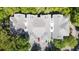 Aerial view of several buildings with grey rooftops surrounded by lush green trees at 60 Fenwick Hall Allee # 432, Johns Island, SC 29455