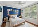 Charming bedroom featuring a blue accent wall, light wood floors, and a ceiling fan at 60 Fenwick Hall Allee # 432, Johns Island, SC 29455