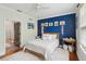 Bright bedroom with a blue accent wall, wood flooring, and a patterned rug at 60 Fenwick Hall Allee # 432, Johns Island, SC 29455