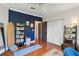Bedroom with a blue accent wall, wood floors, and access to an ensuite bathroom at 60 Fenwick Hall Allee # 432, Johns Island, SC 29455