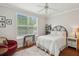 Cozy bedroom featuring a comfortable bed, hardwood floors, and natural light from the large window at 60 Fenwick Hall Allee # 432, Johns Island, SC 29455