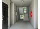 Hallway of a building with a door on the left, stairs, and fire extinguisher at 60 Fenwick Hall Allee # 432, Johns Island, SC 29455