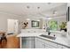 Kitchen view with stainless steel dishwasher and breakfast bar overlooking living space at 60 Fenwick Hall Allee # 432, Johns Island, SC 29455