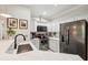 Bright kitchen with stainless steel appliances, white cabinets and stone countertops at 60 Fenwick Hall Allee # 432, Johns Island, SC 29455