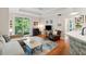 Open-concept living room with hardwood floors, slider to balcony, and modern furniture at 60 Fenwick Hall Allee # 432, Johns Island, SC 29455